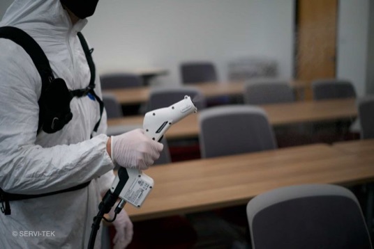 janitor disinfecting office chairs